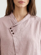 100% linen relaxed V-neck top with asymmetric button detail and short sleeves in cream color
