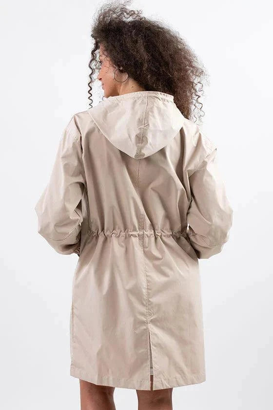 Back view of beige oversized water-resistant windbreaker with hood and adjustable waist
