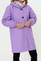 Purple water resistant oversized hooded windbreaker rain jacket on woman with scarf