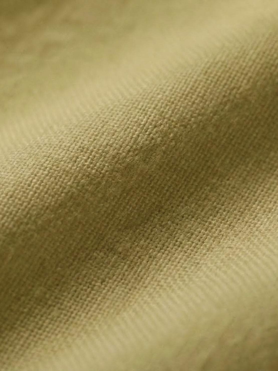 Close-up of soft, breathable cotton fabric in mustard yellow from the Short-sleeved Pullover & Wide Trouser Matching Set