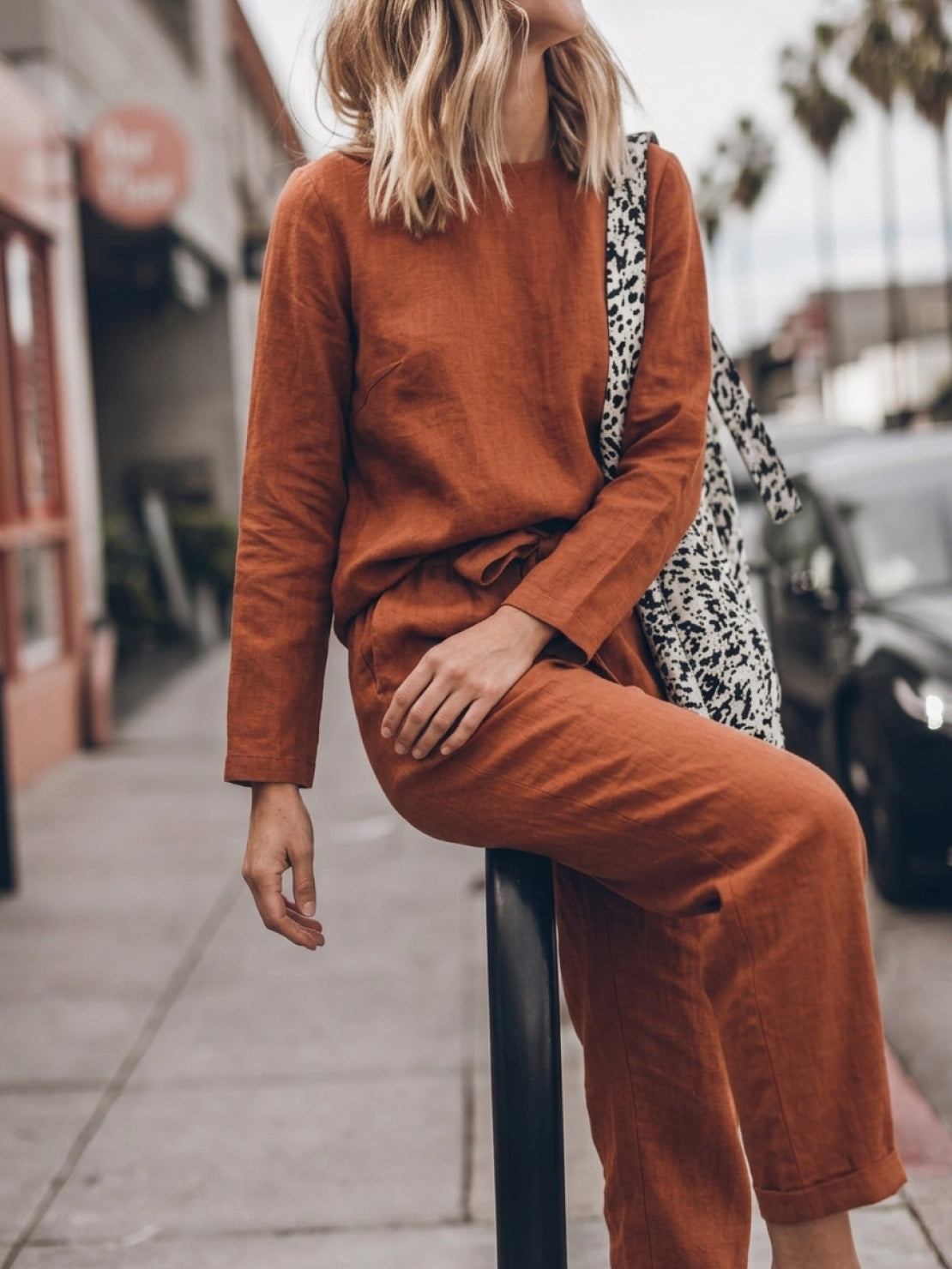 Woman wearing relaxed cotton-linen monochrome capsule outfit with longline top and wide-leg pants