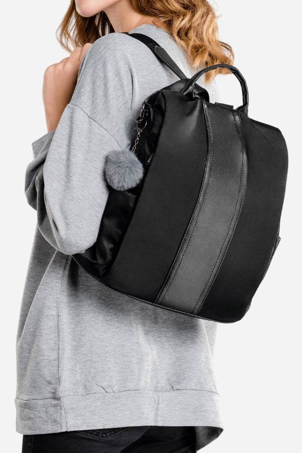 Black anti-theft waterproof fashion backpack with adjustable straps worn by person in gray sweatshirt