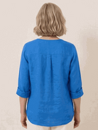 woman wearing pure linen age-defying shirt with button detail outdoors