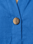 woman wearing pure linen age-defying shirt with button detail in soft coral color