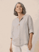 White pure linen age-defying shirt with button detail on hanger