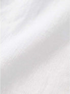 Close-up of soft, breathable white pure linen fabric for age-defying button detail shirt