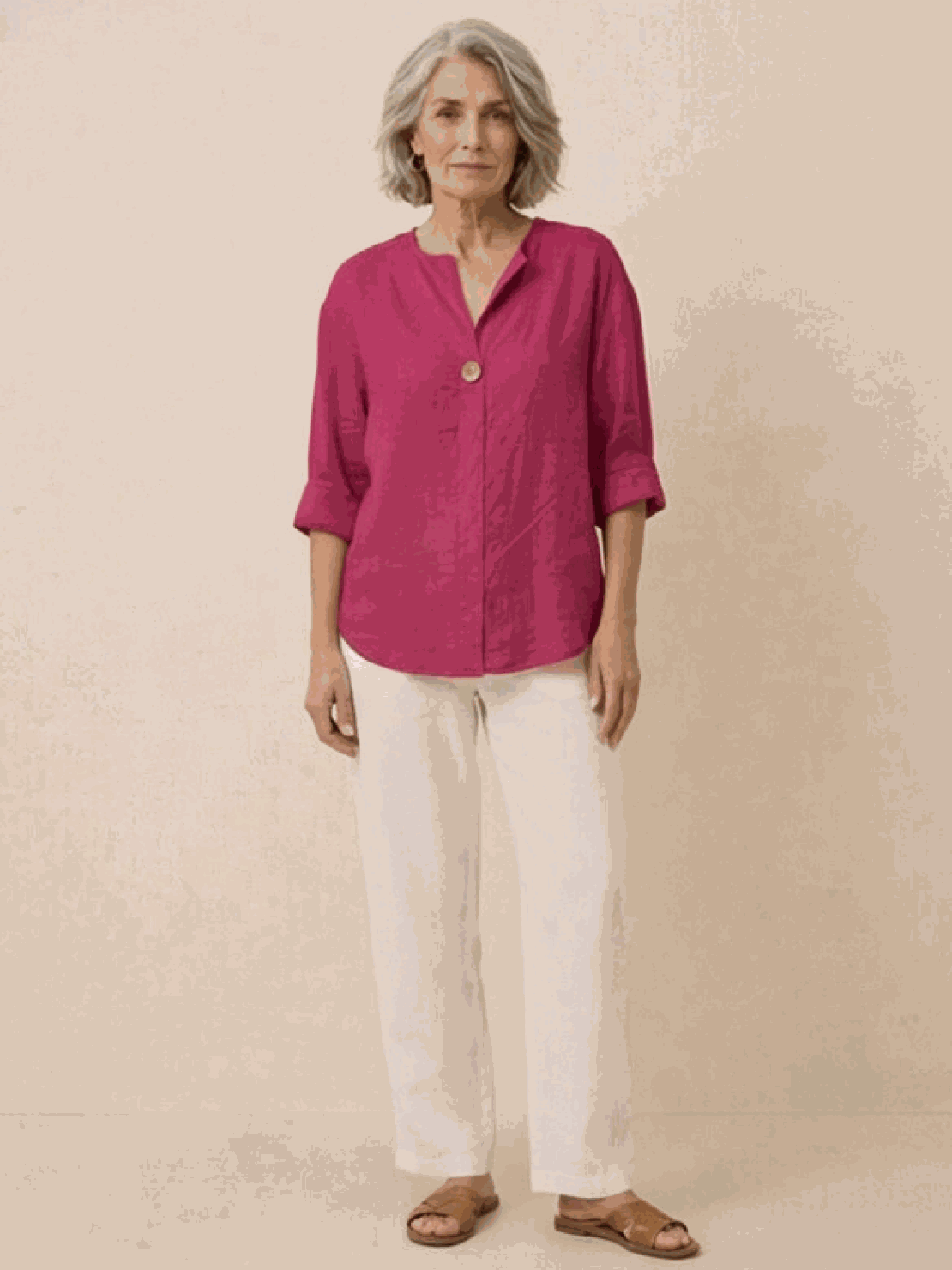 Woman wearing pure linen age-defying shirt with button detail, standing outdoors