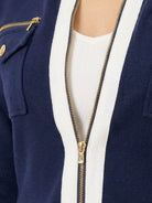 Woman wearing sleek contrast zip two-piece outfit with soft stretch fabric and flattering silhouette