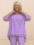 Asymmetrical two-piece trouser set in soft lavender with loose fit and rolled-up sleeves