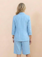 Woman wearing a polished blazer and high-waisted shorts two-piece set in a sleek, monochrome design