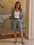 Woman wearing a stylish blazer and high-waisted shorts two-piece set in a polished, coordinated look