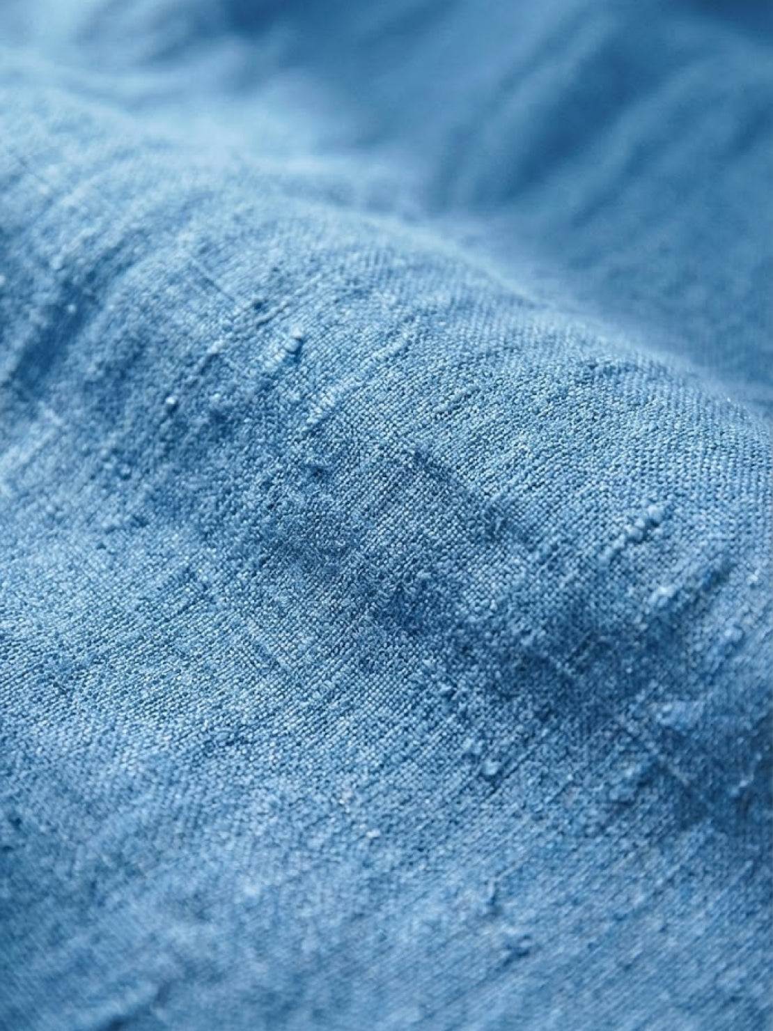 Woman wearing breezy relaxed fit straight pants in orange, styled casually for all-day comfort and chic look