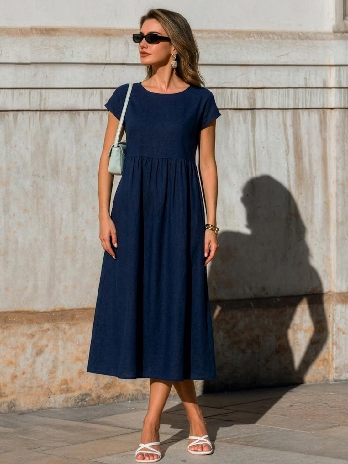Women wearing capped-sleeve voluminous pleated midi dresses in various solid colors, showcasing flowy skirts and pocket details
