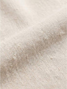 Woman wearing a capped-sleeve voluminous pleated midi dress with a flowy, stomach-flattening drape and pockets