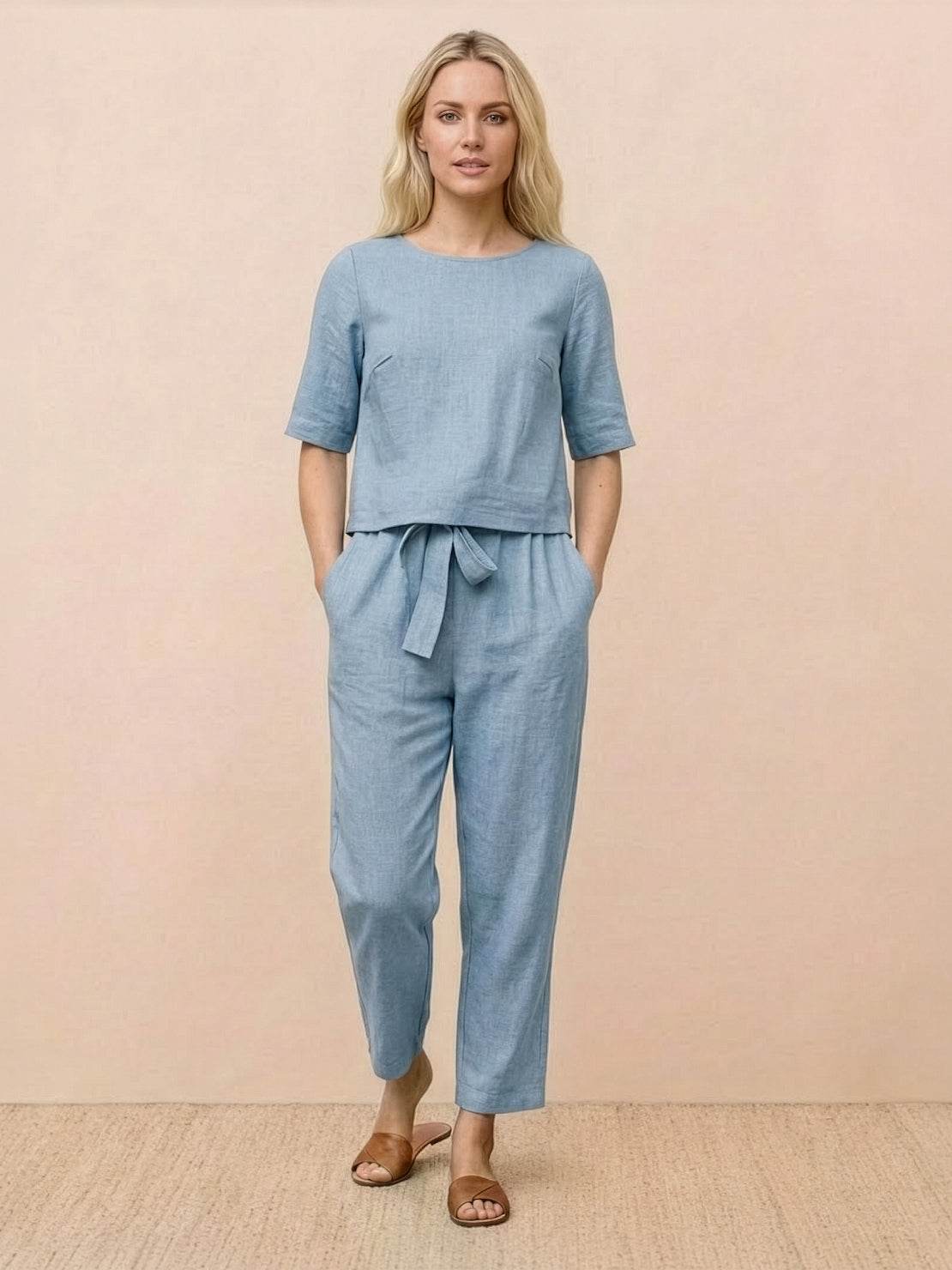 Woman wearing relaxed 100% cotton linen set with short-sleeve top and straight-leg pants in monochrome tones