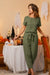 Woman wearing olive green cotton-linen blend monochrome two-piece set standing by Halloween decorated table