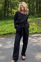 woman wearing black cotton-linen monochrome relaxed longline top and wide-leg pants outdoors