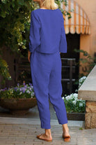 Woman wearing blue cotton-linen monochrome capsule outfit with longline top and wide-leg pants outdoors
