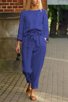 woman wearing blue cotton-linen monochrome relaxed longline top and wide-leg pants walking outdoors