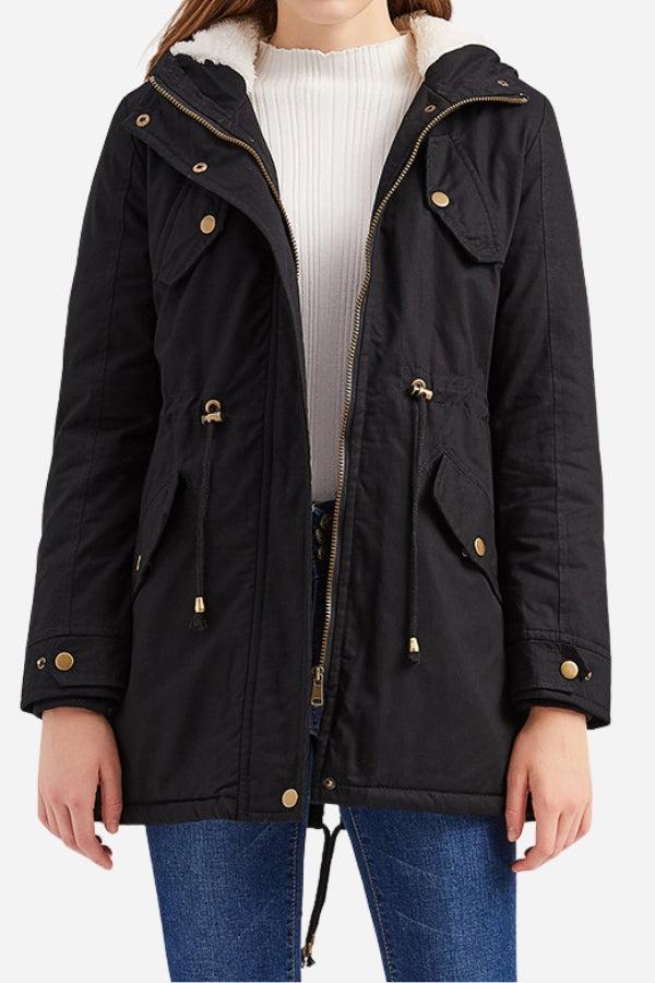 Black extra comfortable cotton parka coat with fluffy lined hood and metal zipper, worn with white sweater and blue jeans.