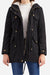 Black extra comfortable cotton parka coat with fluffy lined hood and metal zipper, worn with white sweater and blue jeans.
