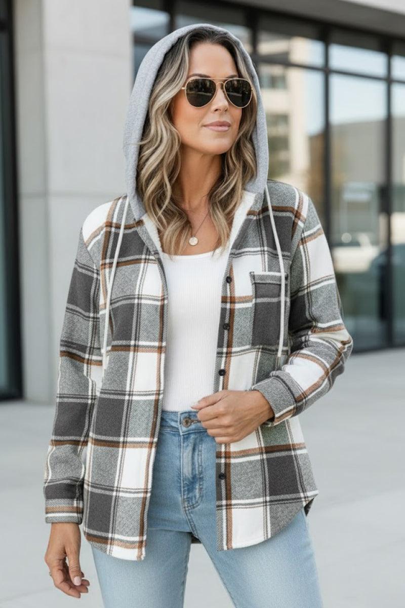 Woman wearing grey and white Highland Plaid Shacket with hood and button-front closure outdoors