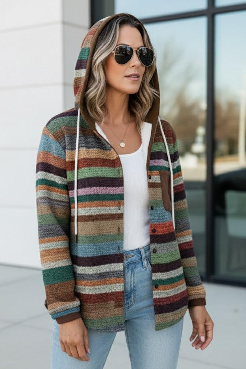 Woman wearing Highland Plaid Shacket with hood, button-front, and multicolor striped pattern over white top and jeans.