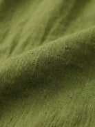 close-up of olive green loose solid color fabric texture