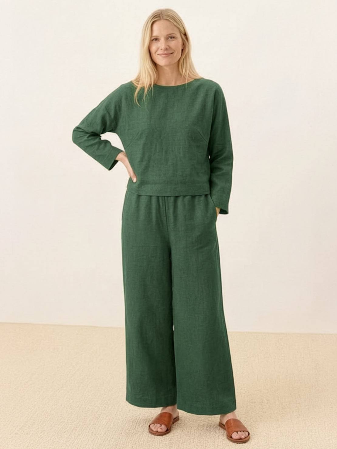 woman wearing loose solid color green two-piece set with long sleeve top and wide-leg pants
