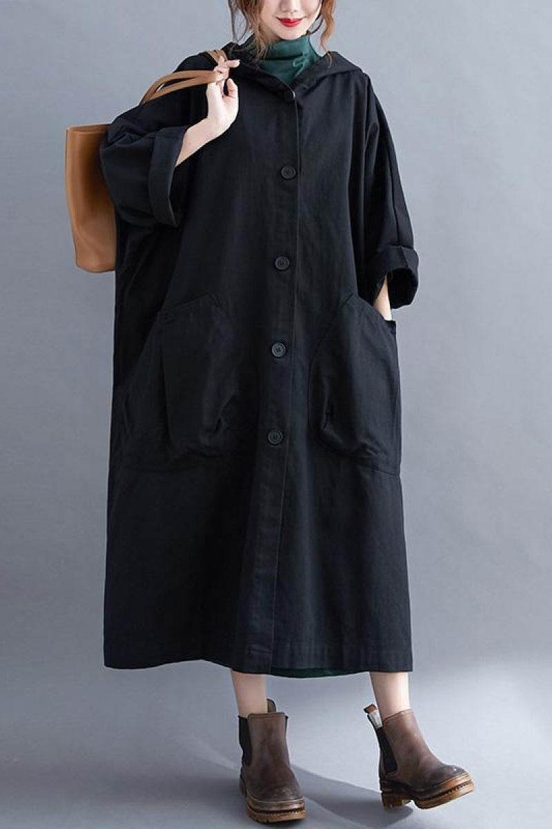 Oversized black water-resistant windbreaker jacket with waterproof design, hood, and large pockets.