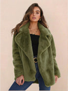 Woman wearing green open front oversized faux fur jacket with draped shawl collar and mid-hip length.