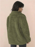 Back view of a woman wearing an olive green open front oversized faux fur jacket with a draped shawl collar and relaxed fit