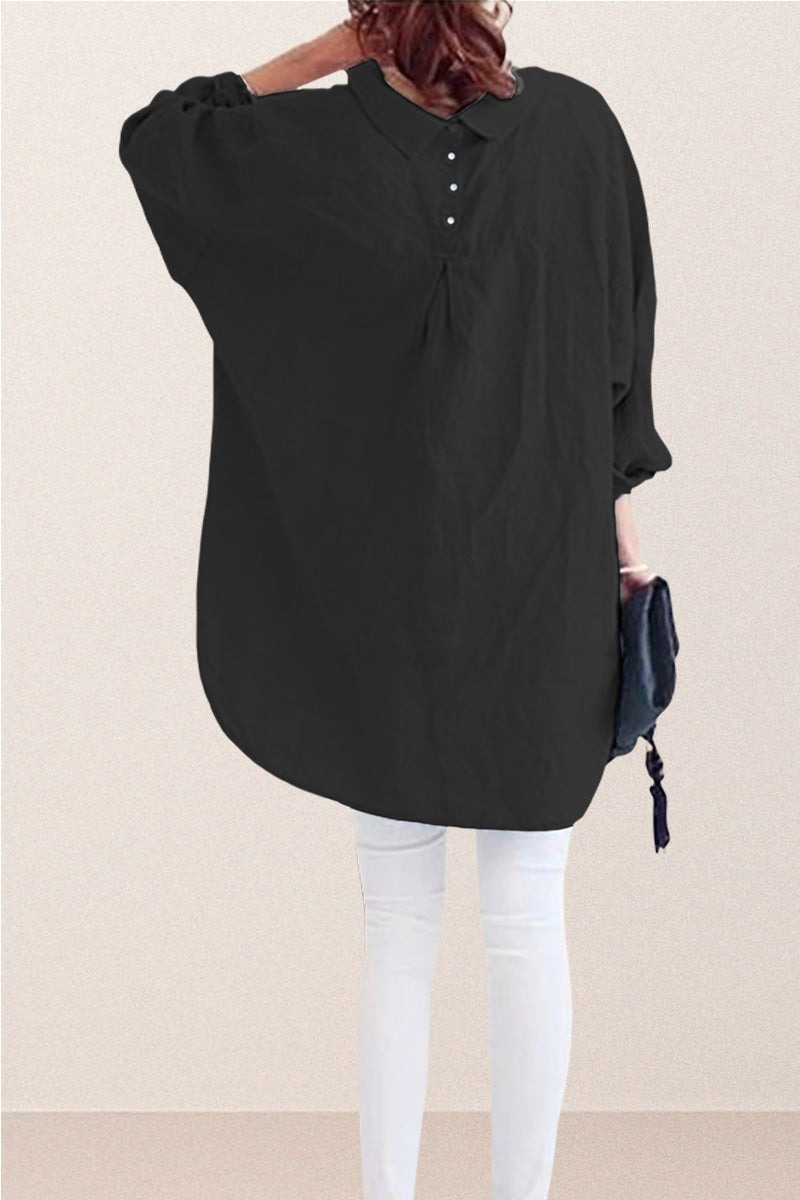 Black oversized linen shirt with back button detail and loose fit worn with white pants