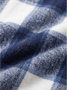 Oversized medium-length blue plaid wool-blend overshirt with long sleeves and functional pockets