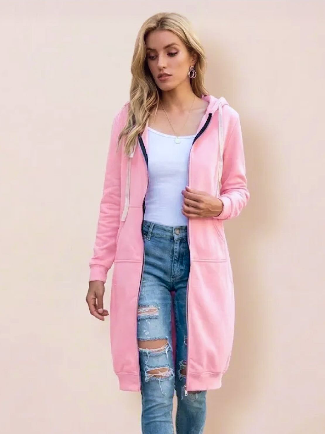 woman wearing pink oversized long zip sweatshirt hoodie with hood and front pockets