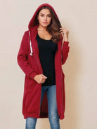 Woman wearing oversized long zip sweatshirt hoodie in red with hood and front pockets