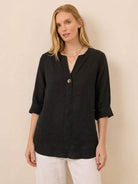 White pure linen age-defying button detail shirt on hanger showcasing breathable, soft fabric