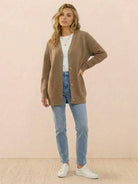 Relaxed fit oversized button down knitwear cardigan in brown worn with jeans and white sneakers
