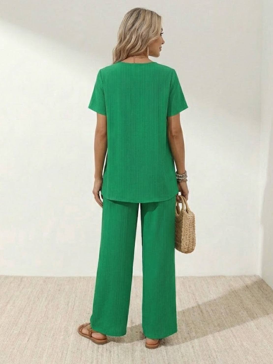 Woman wearing textured elegance two-piece set with asymmetrical top and wide-leg pants