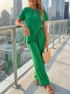 Woman wearing textured elegance two-piece set with asymmetrical top and wide-leg pants