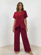 Woman wearing textured elegance two-piece set with asymmetrical top and wide-leg pants