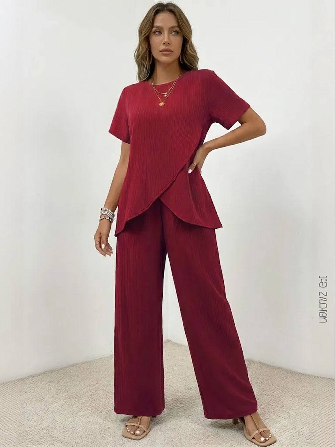 Woman wearing textured elegance two-piece set with asymmetrical top and wide-leg pants