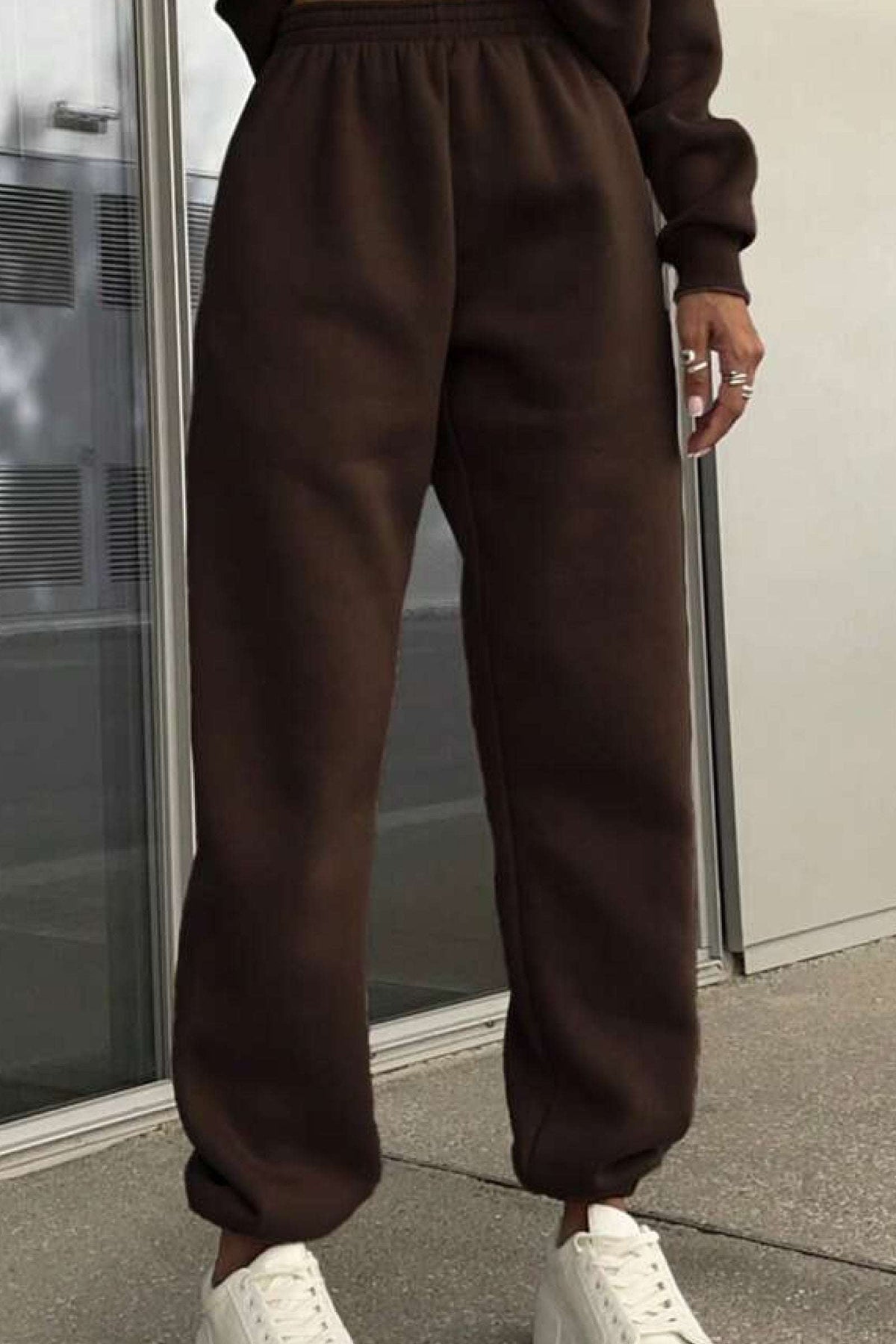 Brown cotton blend tracksuit pants with stretch waistband and cuffs paired with white sneakers, casual and comfortable athleisure wear