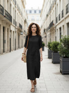 woman wearing Pure Cotton Elegance dress outdoors, soft breathable 100% cotton fabric in light beige