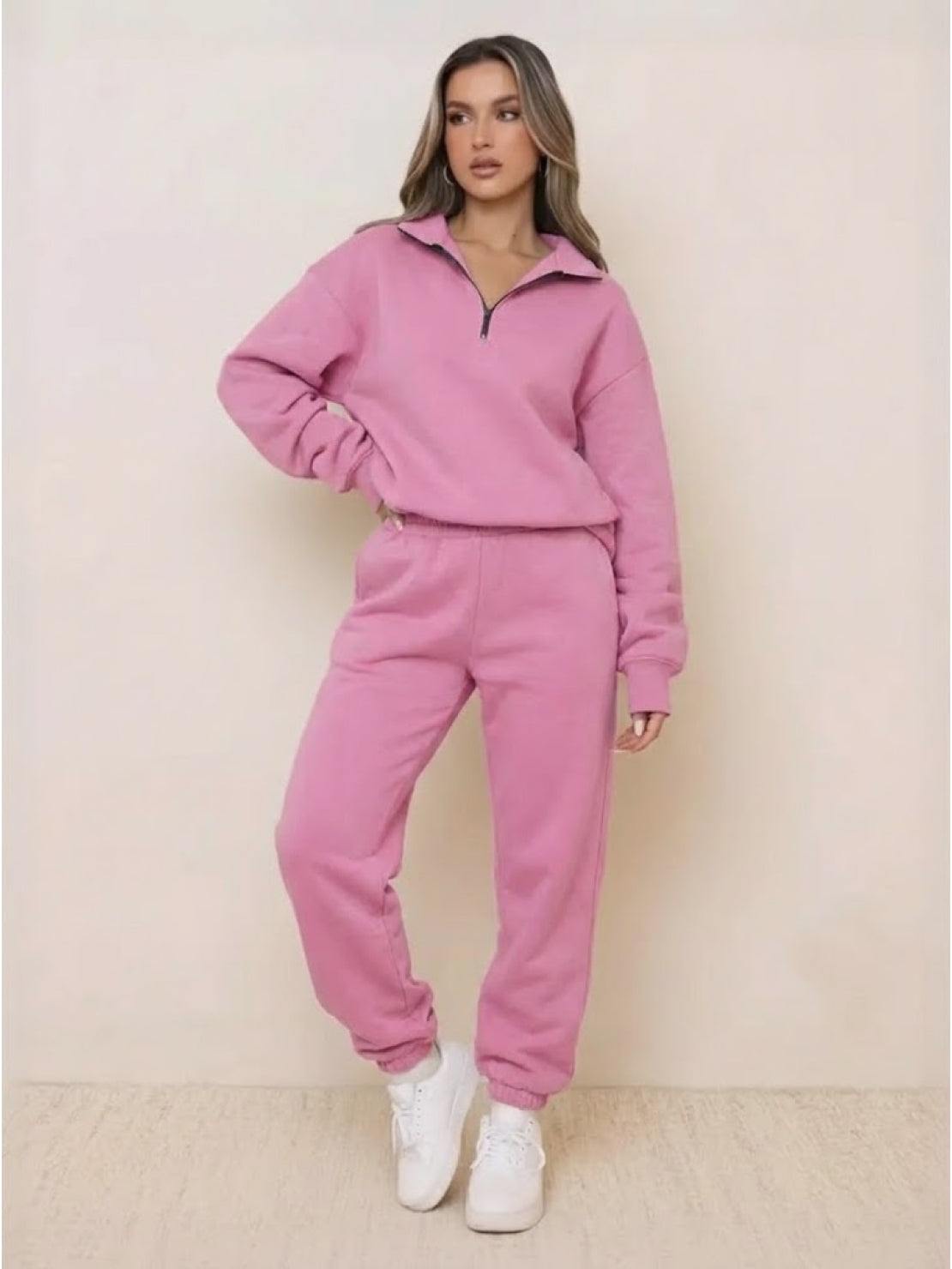 Woman wearing ultra-soft and comfy co-ord tracksuit set in pink with zip-up top and elastic waist pants