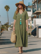 Woman wearing a flowing V-neck two-tiered maxi swing dress with irregular hemline and loose sleeves
