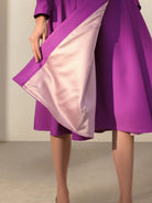 Water-repellent A-line hooded raincoat with insulated lining and matching belt for women