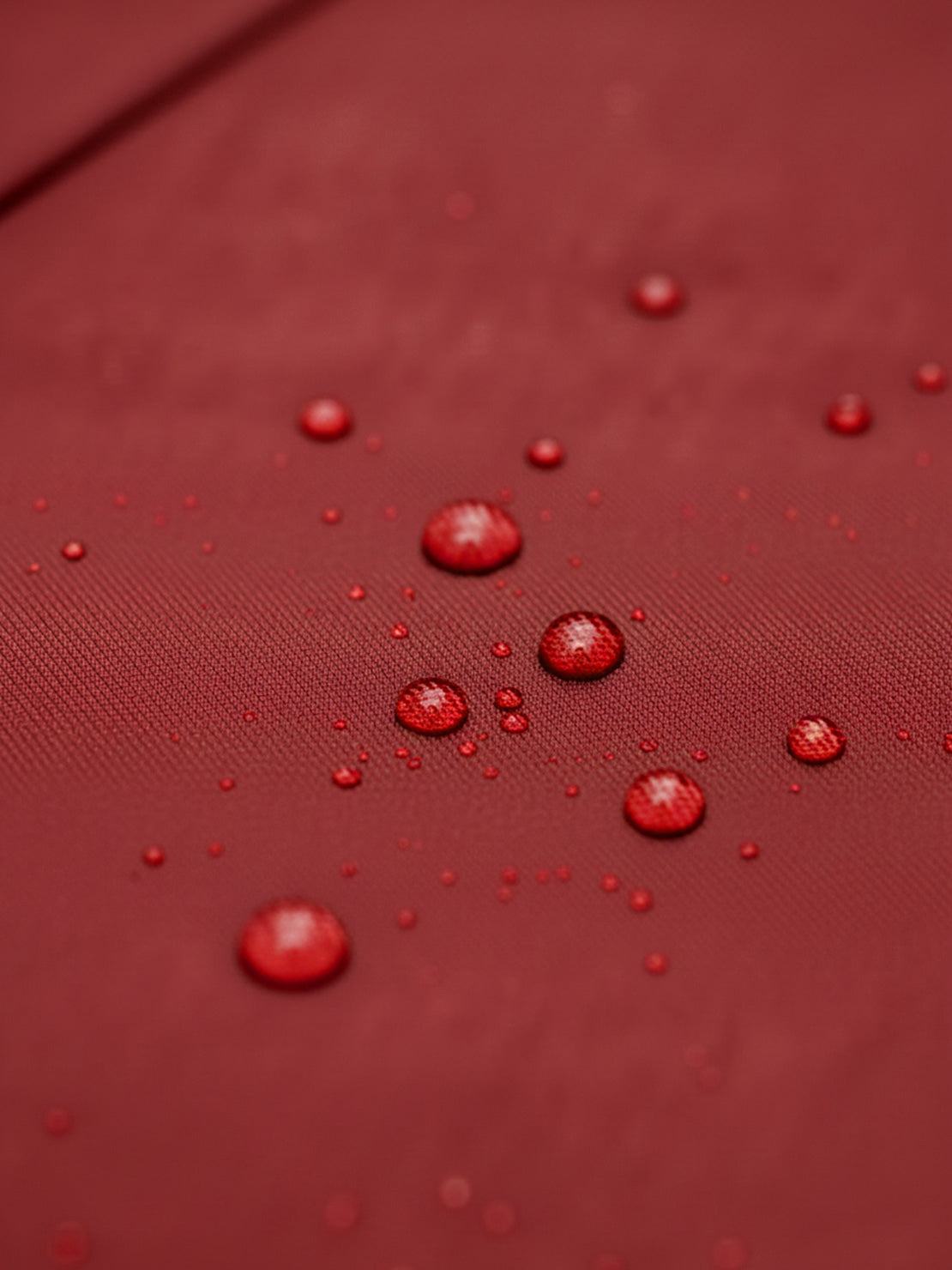 Woman wearing elegant water-repellent rain A-line hooded coat with belt outdoors