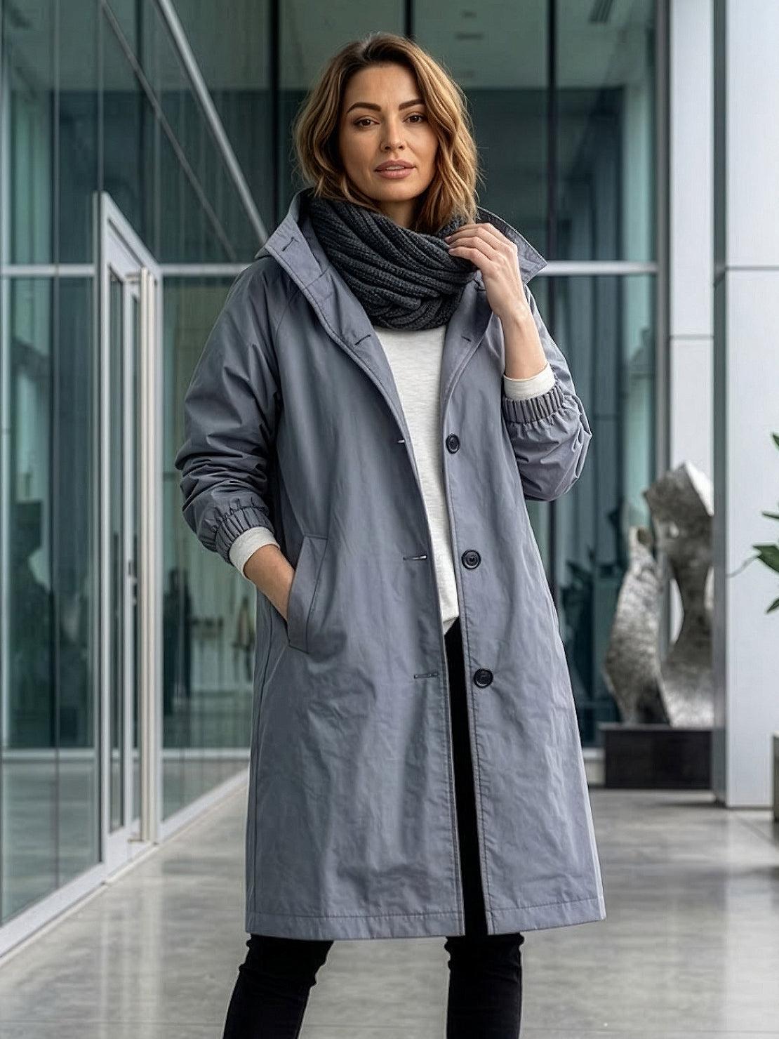 Water-resistant oversized windbreaker rain jacket with hood and pockets for outdoor activities